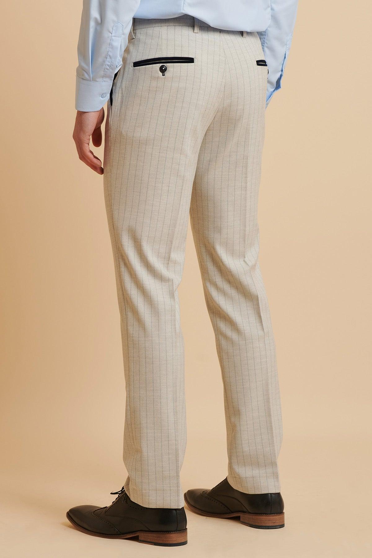 A man's back view wearing The Everton Collection Beto In GRANT Stone Pinstripe Double Breasted Suit by Marc Darcy, paired with a light blue dress shirt and black dress shoes.
