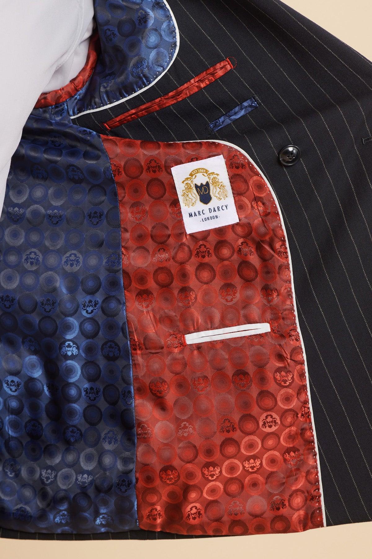 The inside of the Marc Darcy ROCCO Navy Pinstripe Double Breasted Blazer features a shiny blue and red patterned lining, a white trim pocket, and a Marc Darcy label with gold lion crest.