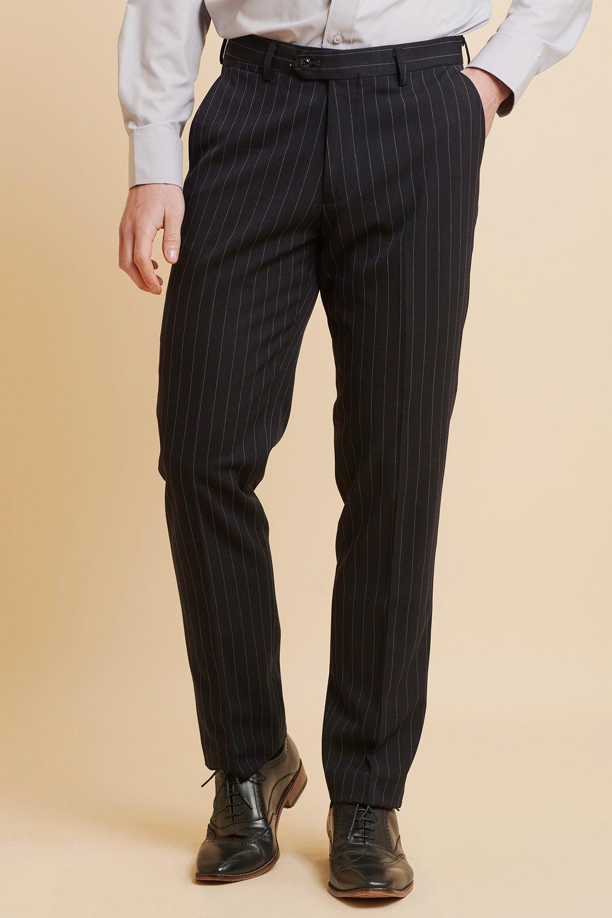 A person wearing a light gray dress shirt, Marc Darcy ROCCO Navy Pinstripe Trousers, and black dress shoes stands against a beige background. The image is cropped at the shoulders.
