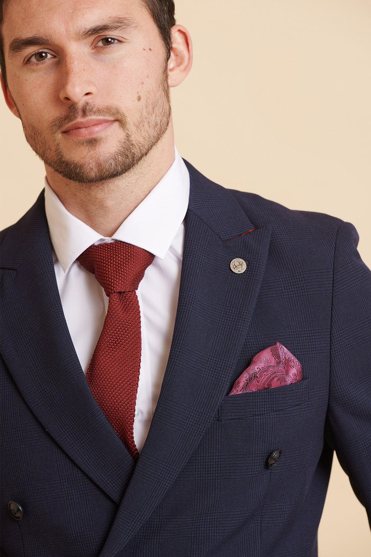 A man in a Marc Darcy Official West Ham United Club BROMLEY Navy Double Breasted Suit with a white shirt, red tie, and pink paisley pocket square.