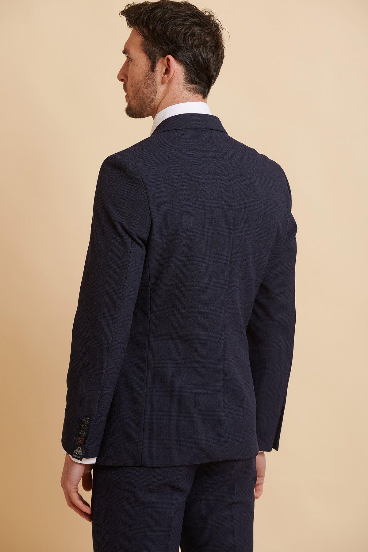Back view of a man wearing the Official West Ham United Club Suit—the BROMLEY navy double breasted suit by Marc Darcy—paired with a white dress shirt.