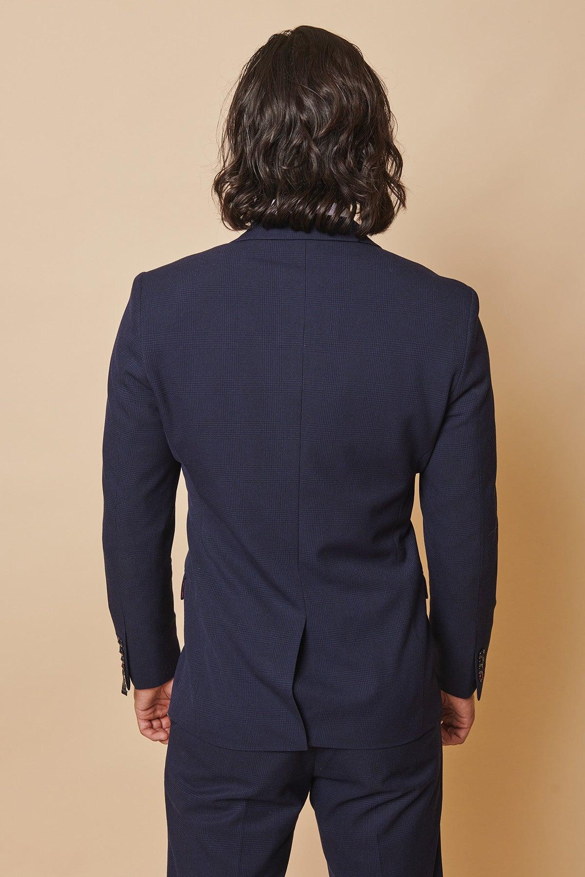 Back view of former Sunderland footballer Michael Gray with long dark hair, wearing a Marc Darcy Bromley Navy Double-Breasted Suit.