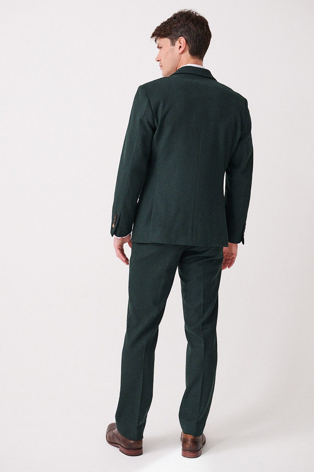 A man faces away from the camera, wearing the marcdarcy ARCHIE Forest Tweed Three Piece Suit with matching trousers and brown dress shoes, set against a plain white background.