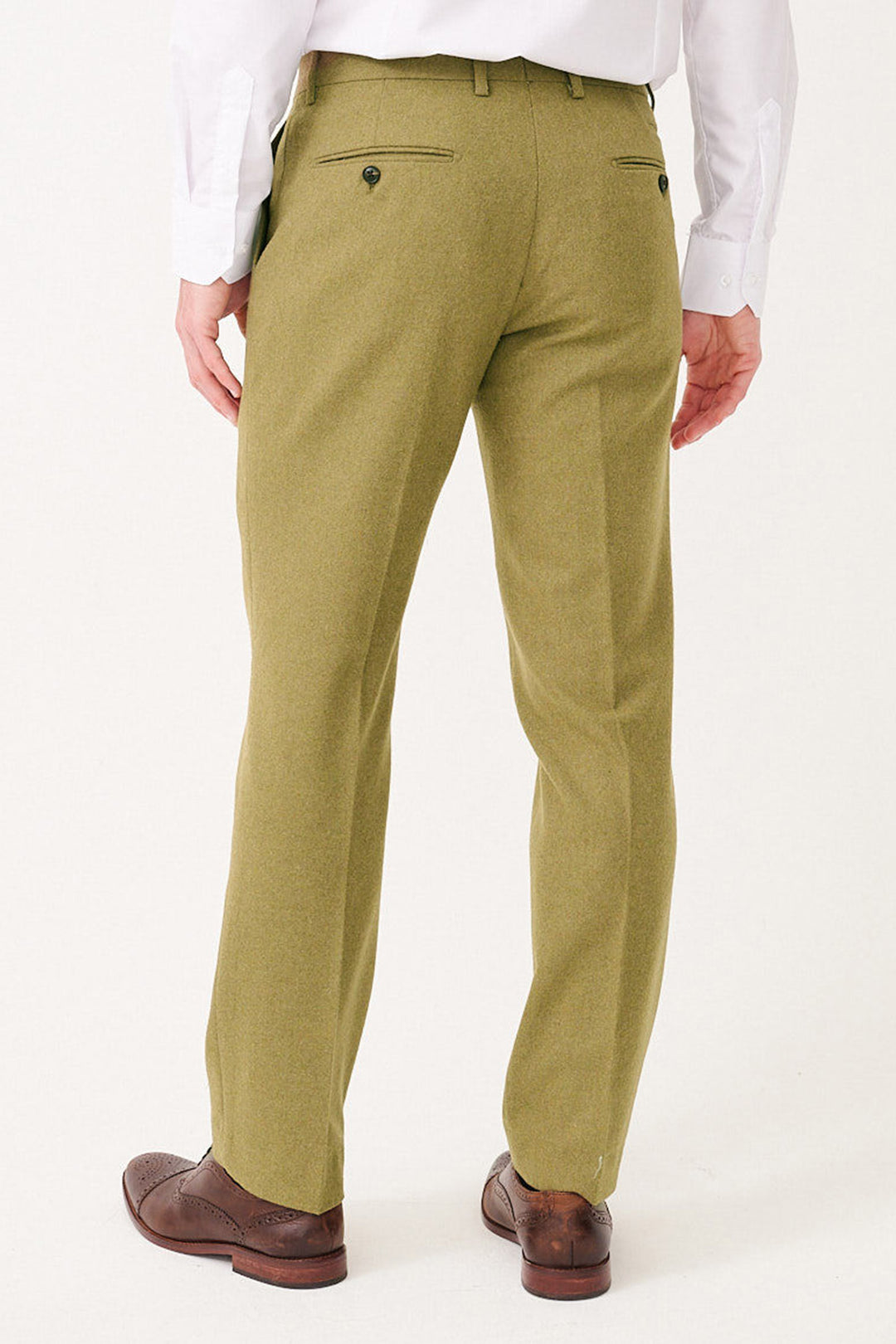 A man in a white shirt and marcdarcy ARCHIE Moss Tweed Trousers, viewed from the back, paired with brown leather brogue shoes.