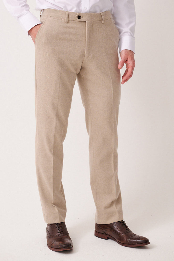 A person models the marcdarcy ARCHIE - Stone Tweed Three Piece Suit, showcasing its slim fit trousers against a plain light background. The image focuses on the lower half of the suit.