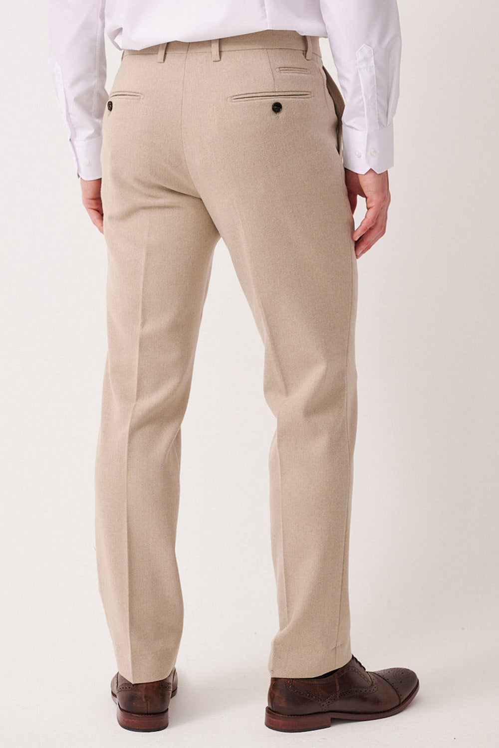 A man is shown from the back wearing marcdarcy's ARCHIE - Stone Tweed Trousers with belt loops, buttoned rear pockets, a tailored slim fit, paired with a white dress shirt and brown dress shoes.