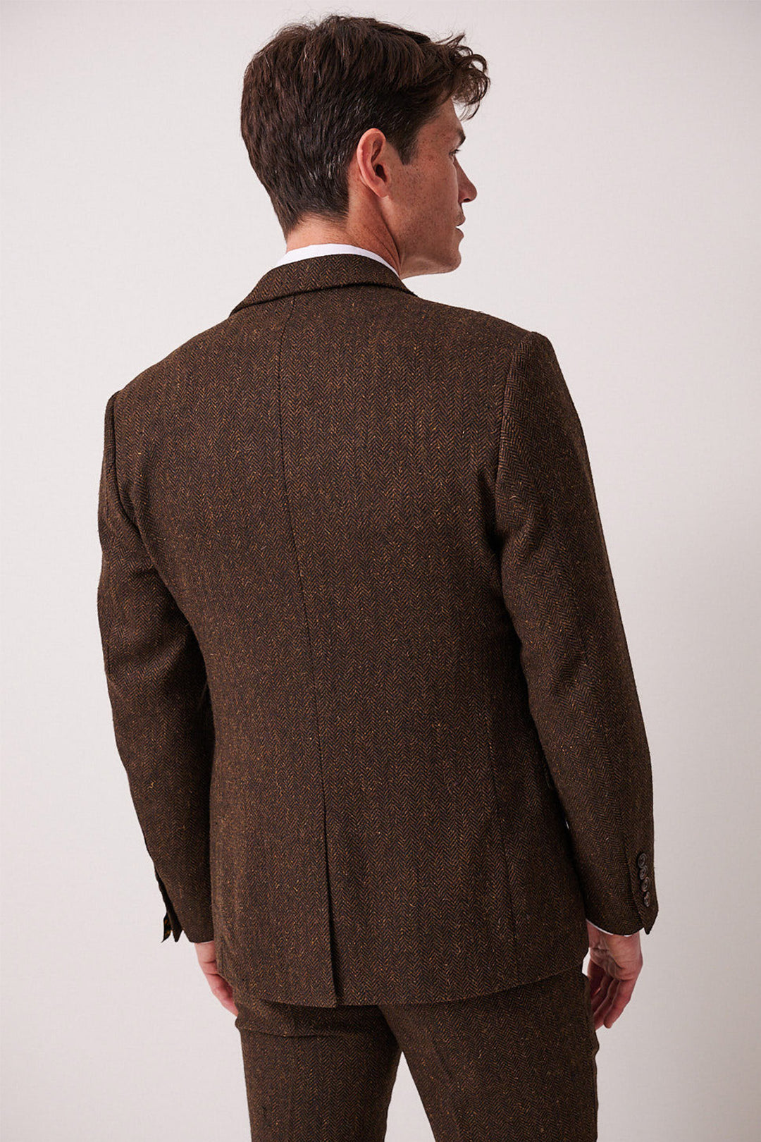 A man shown from the back wears the marcdarcy DEAN Brown Tweed Blazer, featuring a slim fit and prominent center seam, set against a plain light background.