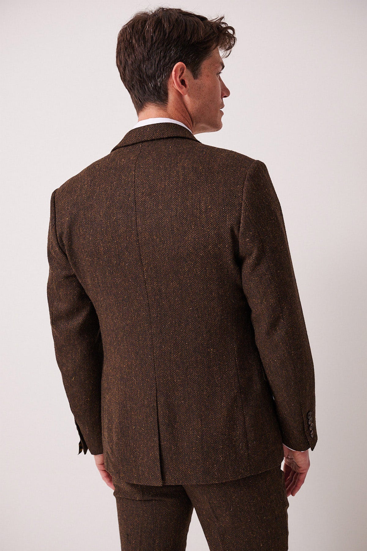 A man shown from the back wears the marcdarcy DEAN Brown Tweed Blazer, featuring a slim fit and prominent center seam, set against a plain light background.