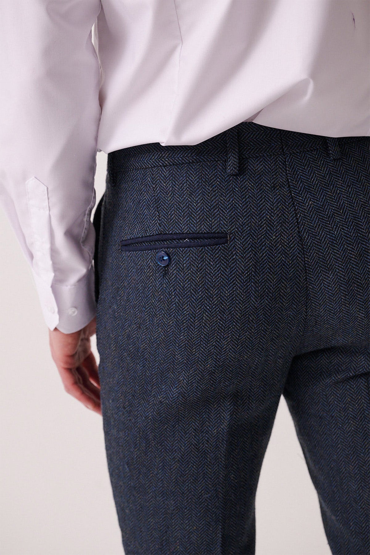 Close-up of a man's back wearing marcdarcy's DEAN - Blue Tweed Trousers, slim fit with a single back pocket, navy trim, and button.
