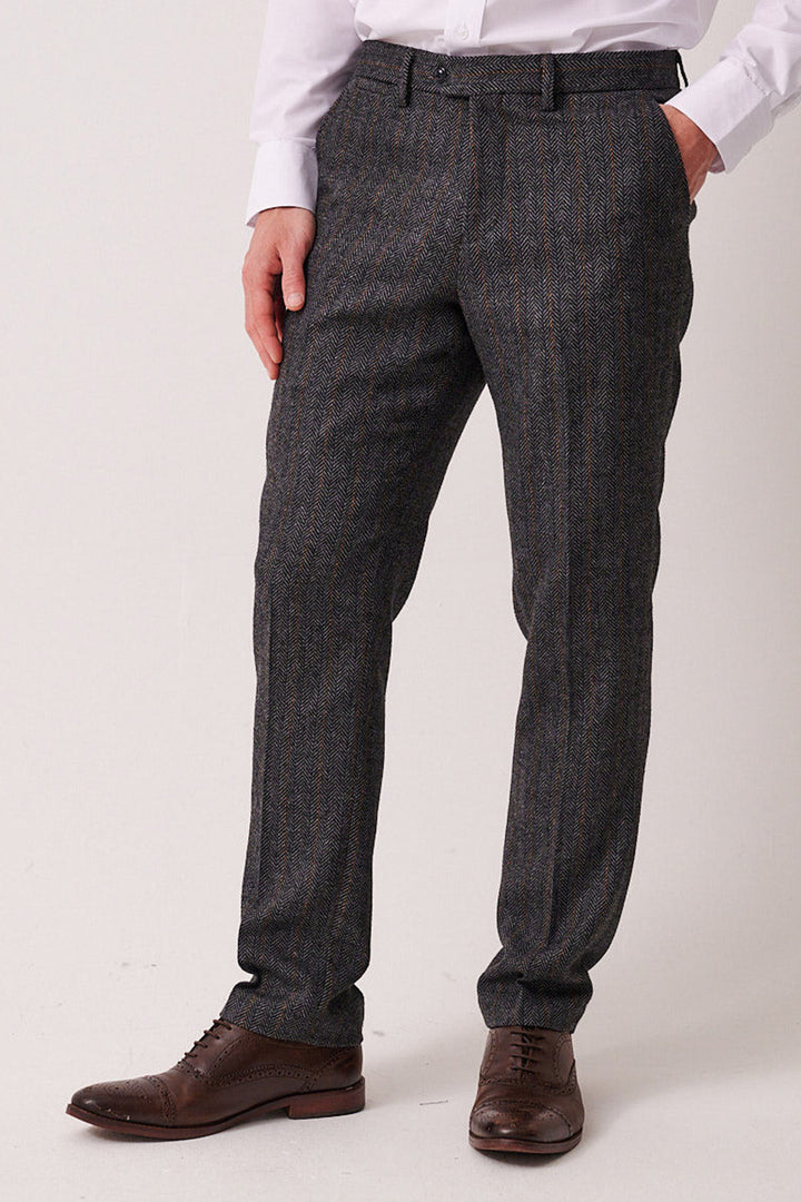 A person wearing the marcdarcy DOMINIC Blue Grey Tweed Three Piece Suit stands with hands in pockets against a plain white background.