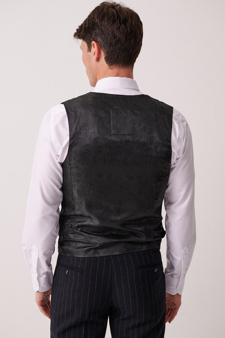 A man is shown from behind wearing the Marc Darcy HANSON Navy Tweed Pinstripe Waistcoat over a white dress shirt and dark pinstripe trousers, against a plain, neutral background.