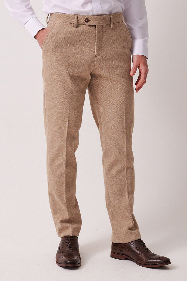 A person models the marcdarcy HAYDEN - Oak Crossweave Three Piece Suit, showcasing tan dress pants and a white shirt with brown shoes against a light background. Only the lower half is visible, highlighting classic style and slim fit.