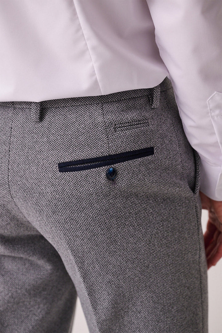 Close-up of marcdarcy HAYDEN Silver Blue Crossweave Trousers, slim fit with a dark blue piped back pocket and matching button, styled smart casual with a white shirt.