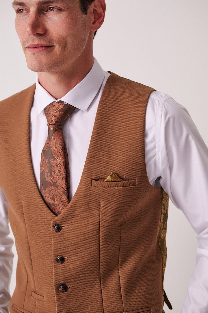 A man wears the marcdarcy DX7 Tan Tweed Check Suit with Kelvin Oak Waistcoat over a white shirt, styled with a paisley tie and patterned pocket square—perfect for a country wedding or vintage-inspired look.