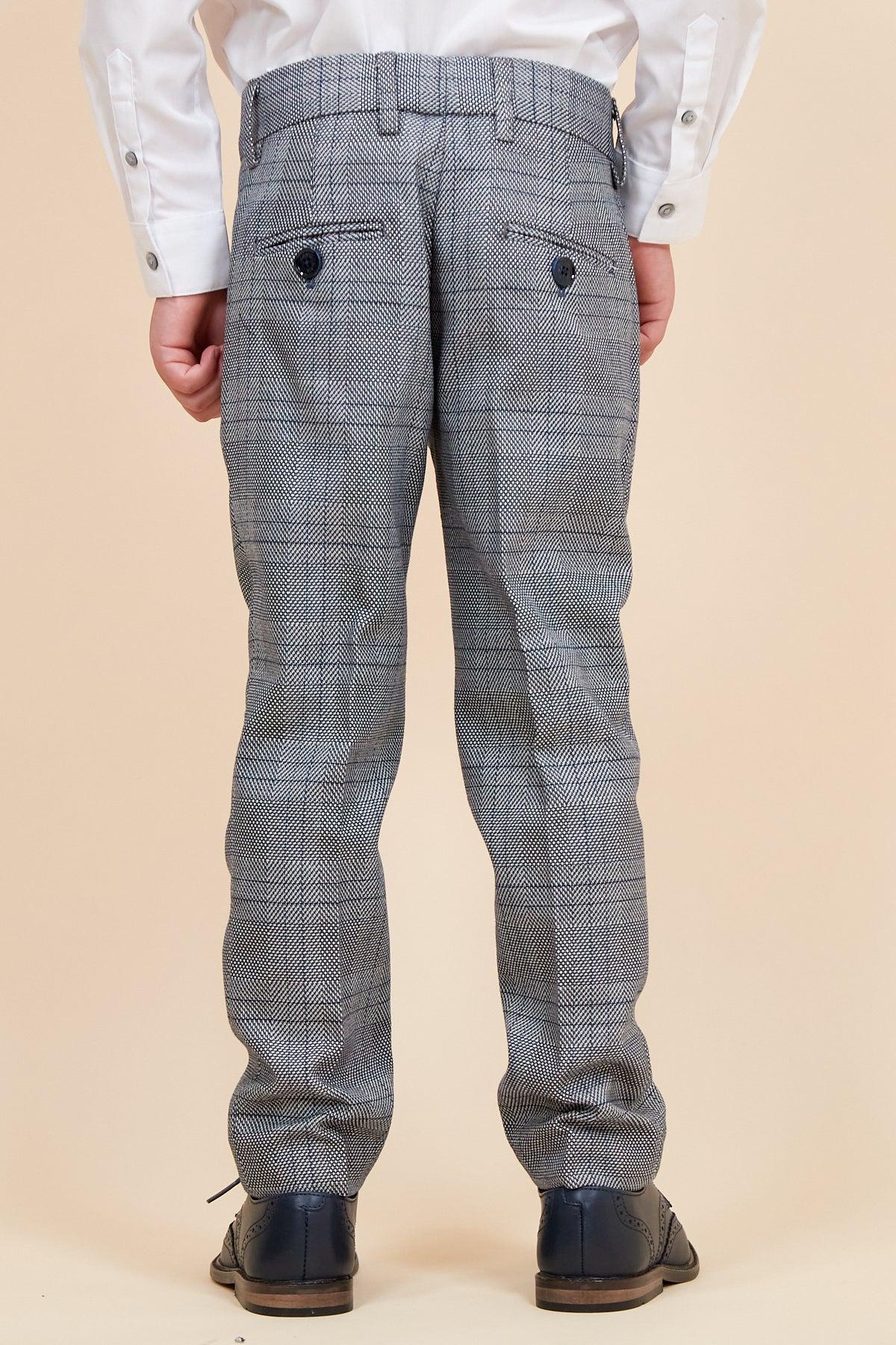 A child models the marcdarcy JERRY Childrens Grey Check Three Piece Suit, featuring a white shirt and dress shoes, shown from the back against a beige background.