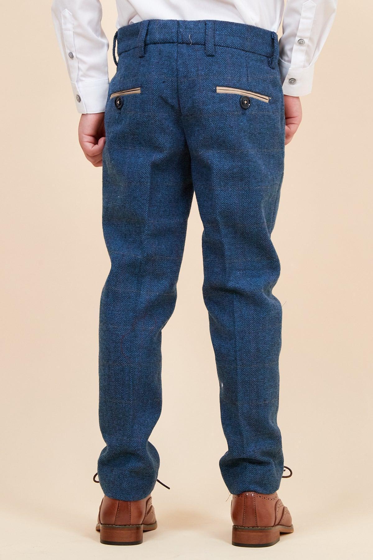 Back view of a child in the marcdarcy DION Children's Blue Tweed Check Three Piece Suit, featuring a white dress shirt and brown shoes—a stylish choice for special occasions.