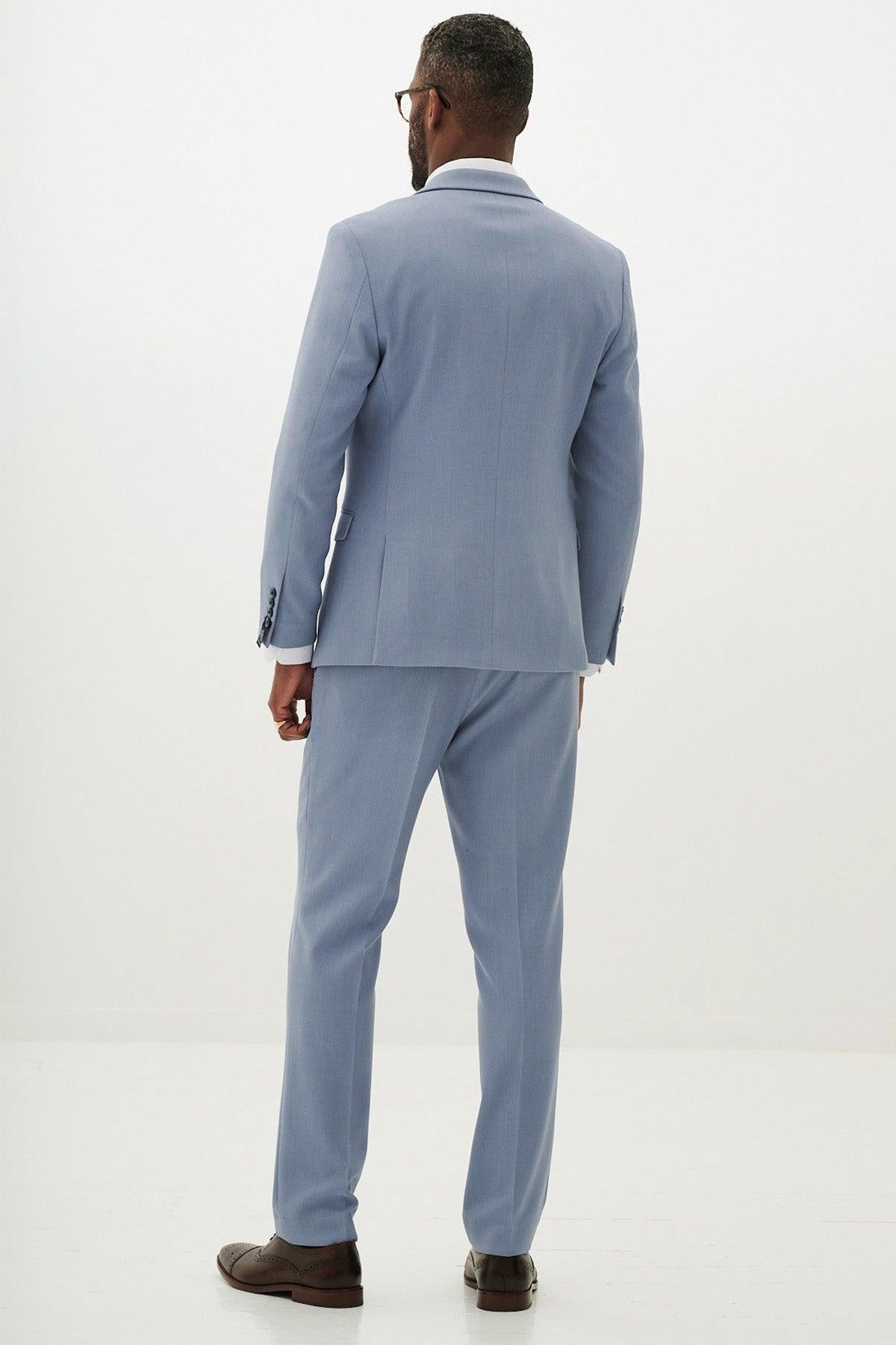 A man wearing the marcdarcy HM5 - Sky Blue Tailored Blazer is seen from the back, paired with glasses and brown dress shoes.