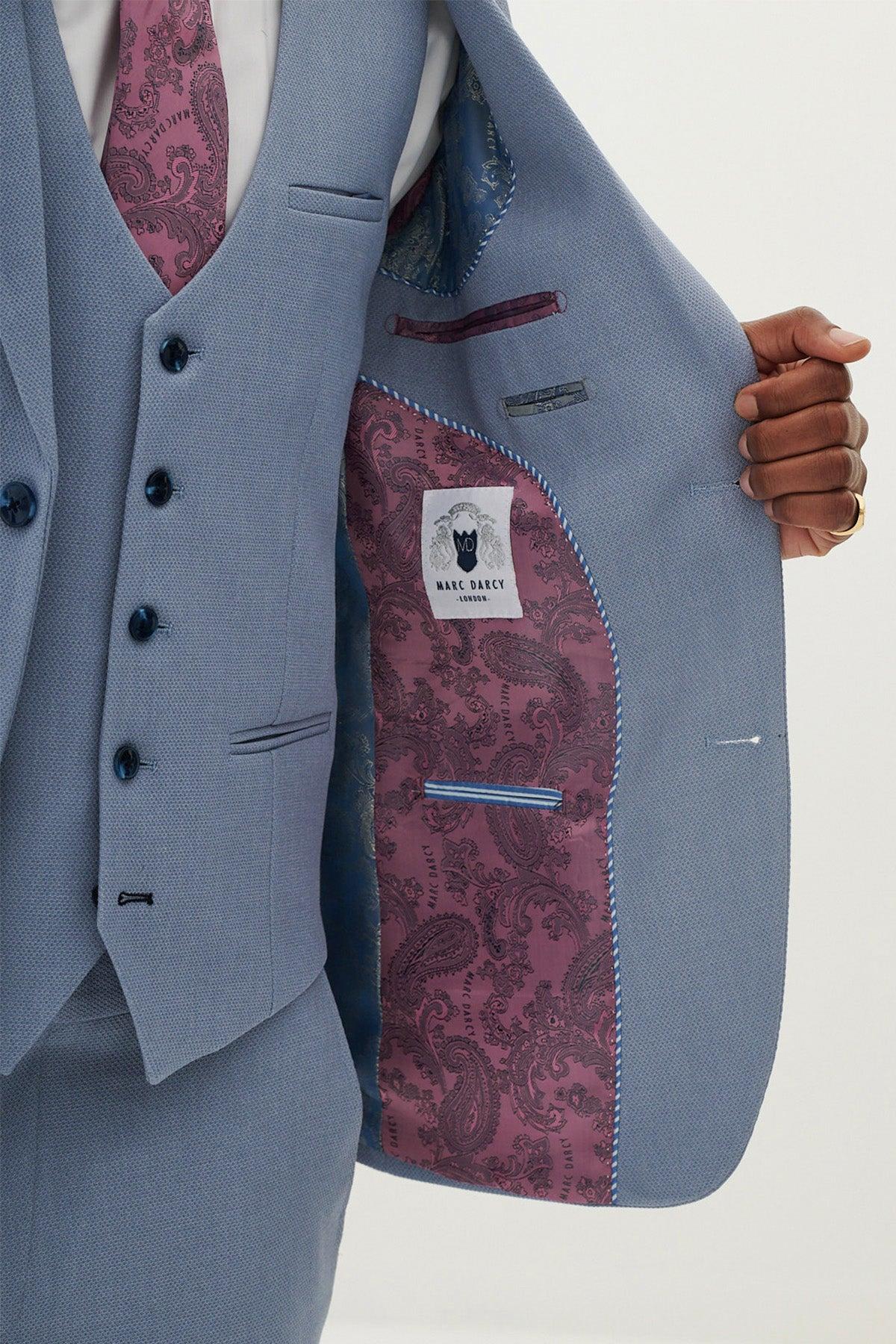 Close-up of the HM5 - Sky Blue Three Piece Suit by Marc Darcy, featuring a jacket, vest, tie, and a purple paisley lining with the Marc Darcy London logo.