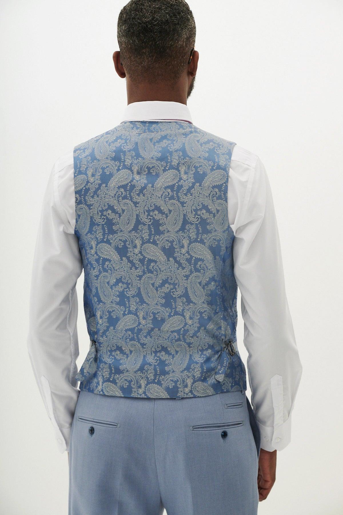 Back view of a man wearing the Marc Darcy HM5 - Sky Blue Three Piece Suit, featuring a textured vest over a white shirt and light blue pants—perfect for men's wedding attire.