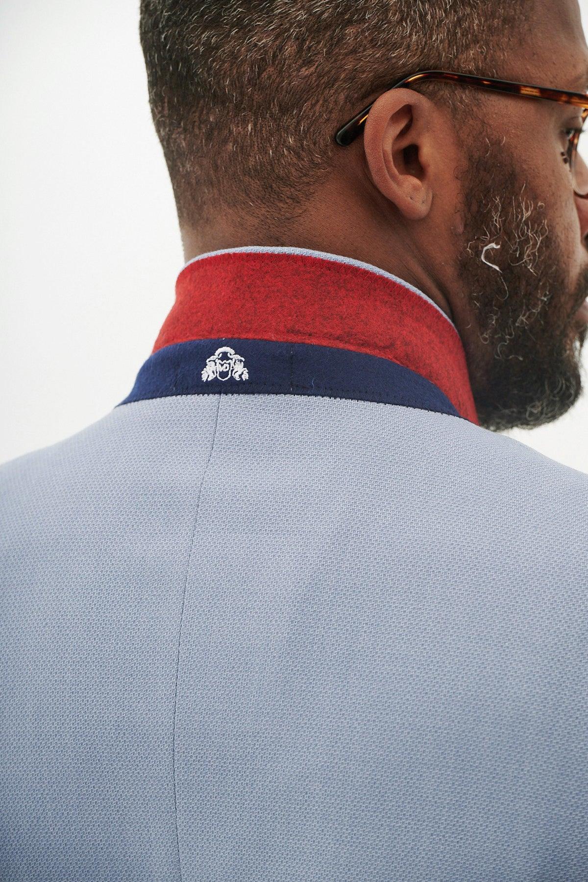 Close-up back view of a man wearing the Marc Darcy HM5 - Sky Tailored Two Piece Suit. He has a beard and tortoiseshell glasses.