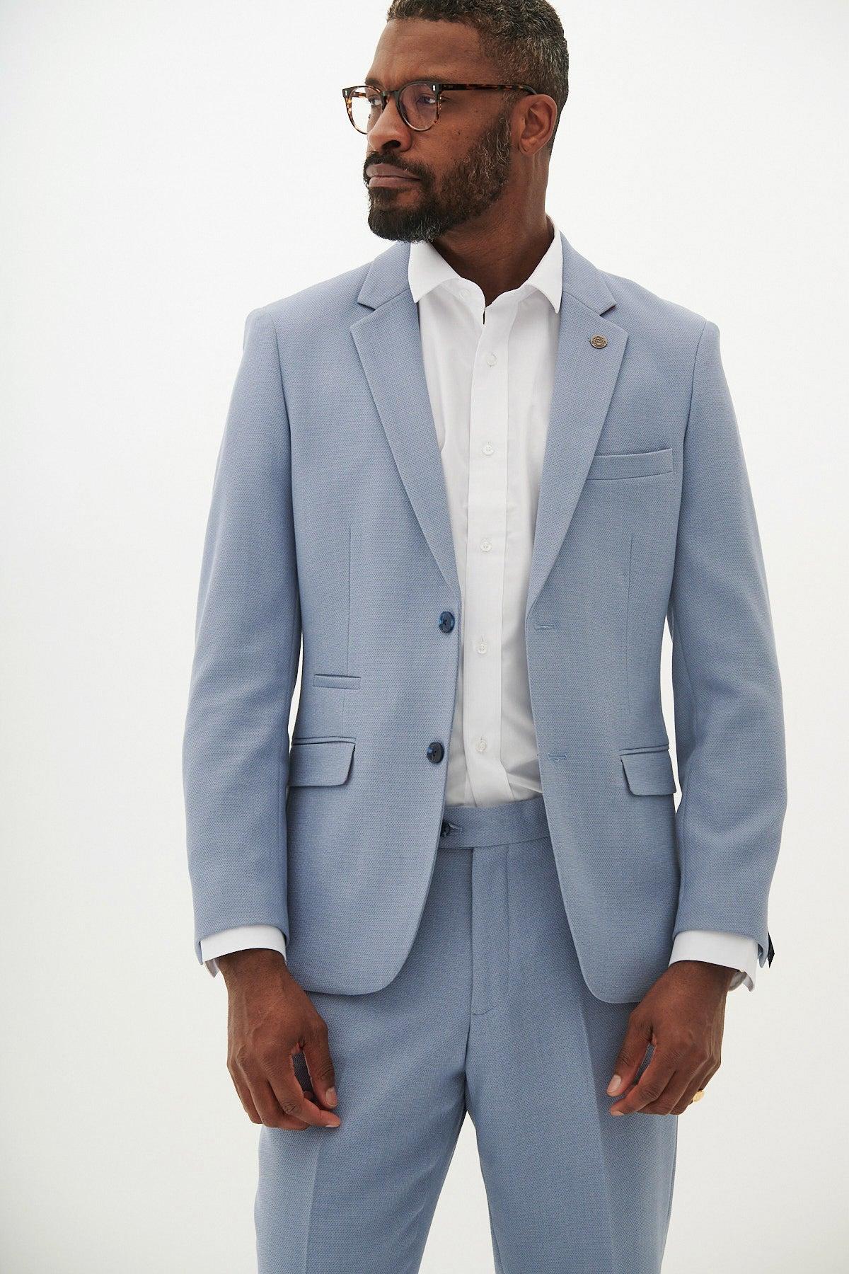A man wearing glasses and a marcdarcy HM5 - Sky Blue Tailored Blazer over a white shirt stands against a plain white background, looking left with a neutral expression.