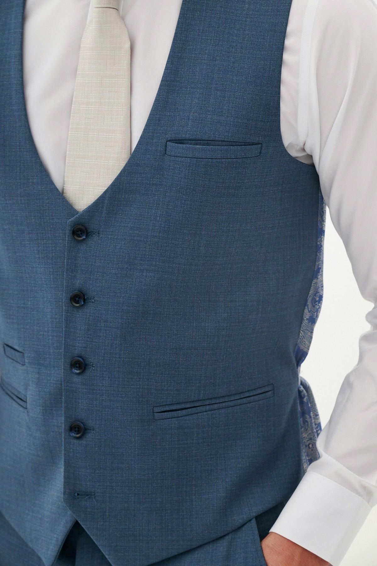 Close-up of a man wearing the Marc Darcy FINLEY - Teal Blue Single Breasted Waistcoat over a white shirt and light-colored textured tie, ideal for summer formalwear.