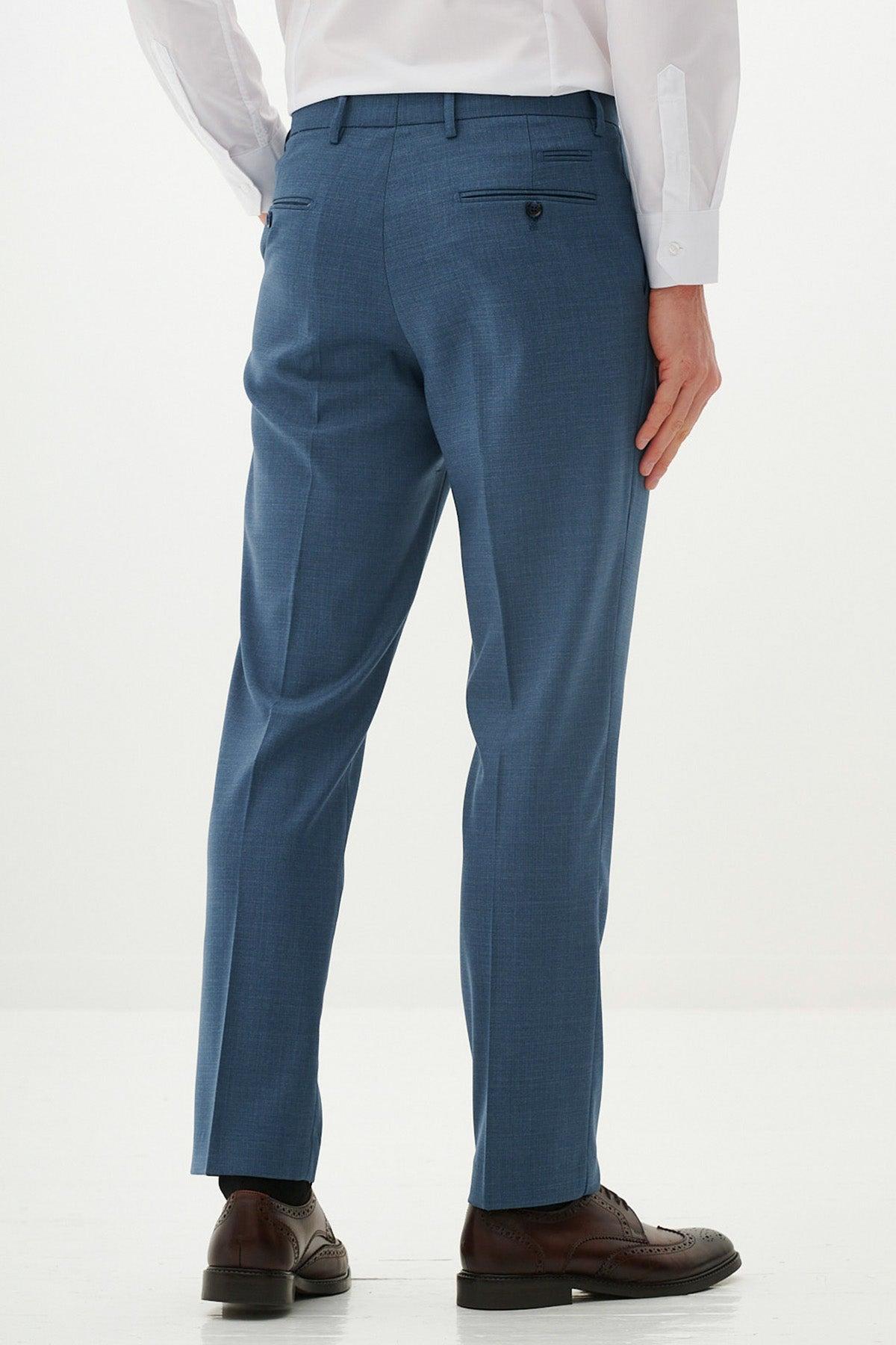 A man in a white shirt and brown dress shoes models the Marc Darcy FINLEY - Teal Blue Tailored Trousers, standing against a white background and showcasing the back view.