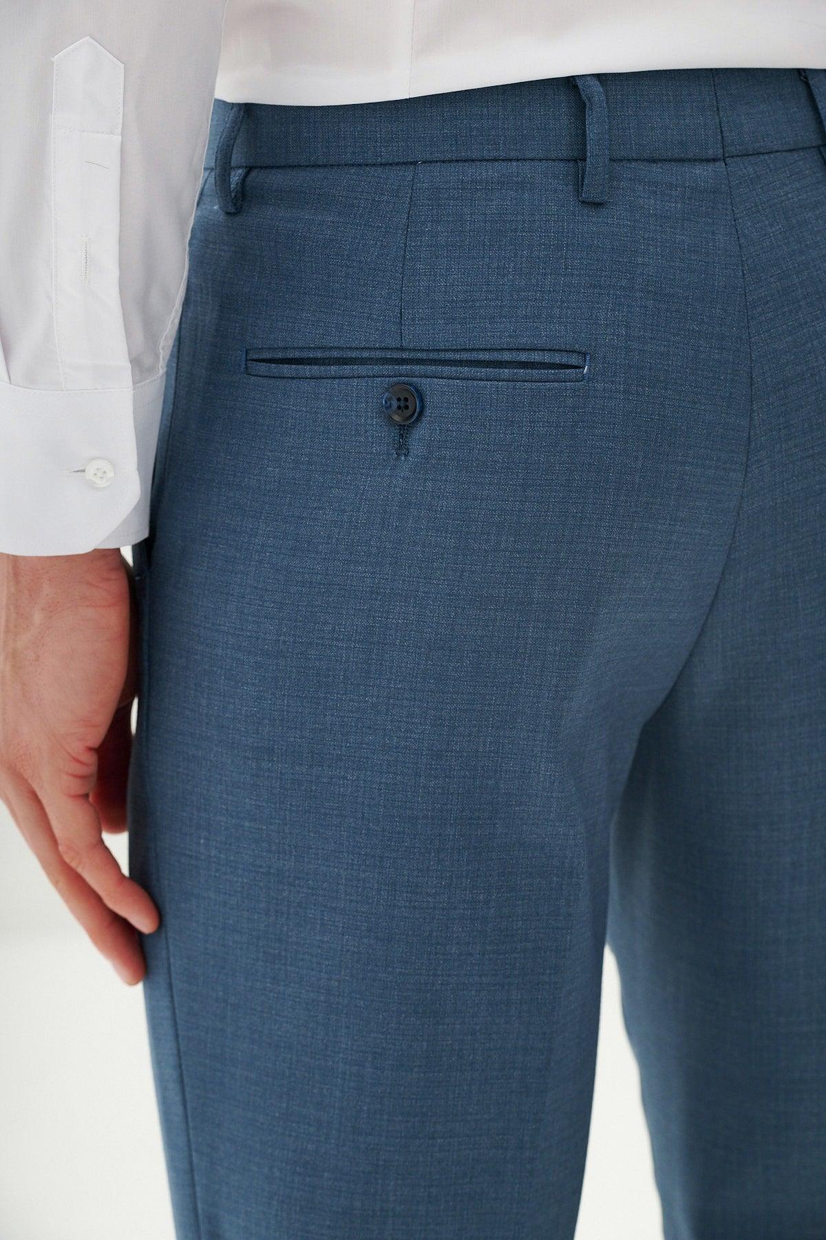A person wears the Marc Darcy FINLEY Teal Blue Three Piece Suit with a crisp white shirt, highlighting the back pockets button closure. Their left hand rests at their side—ideal for summer weddings or formal occasions.
