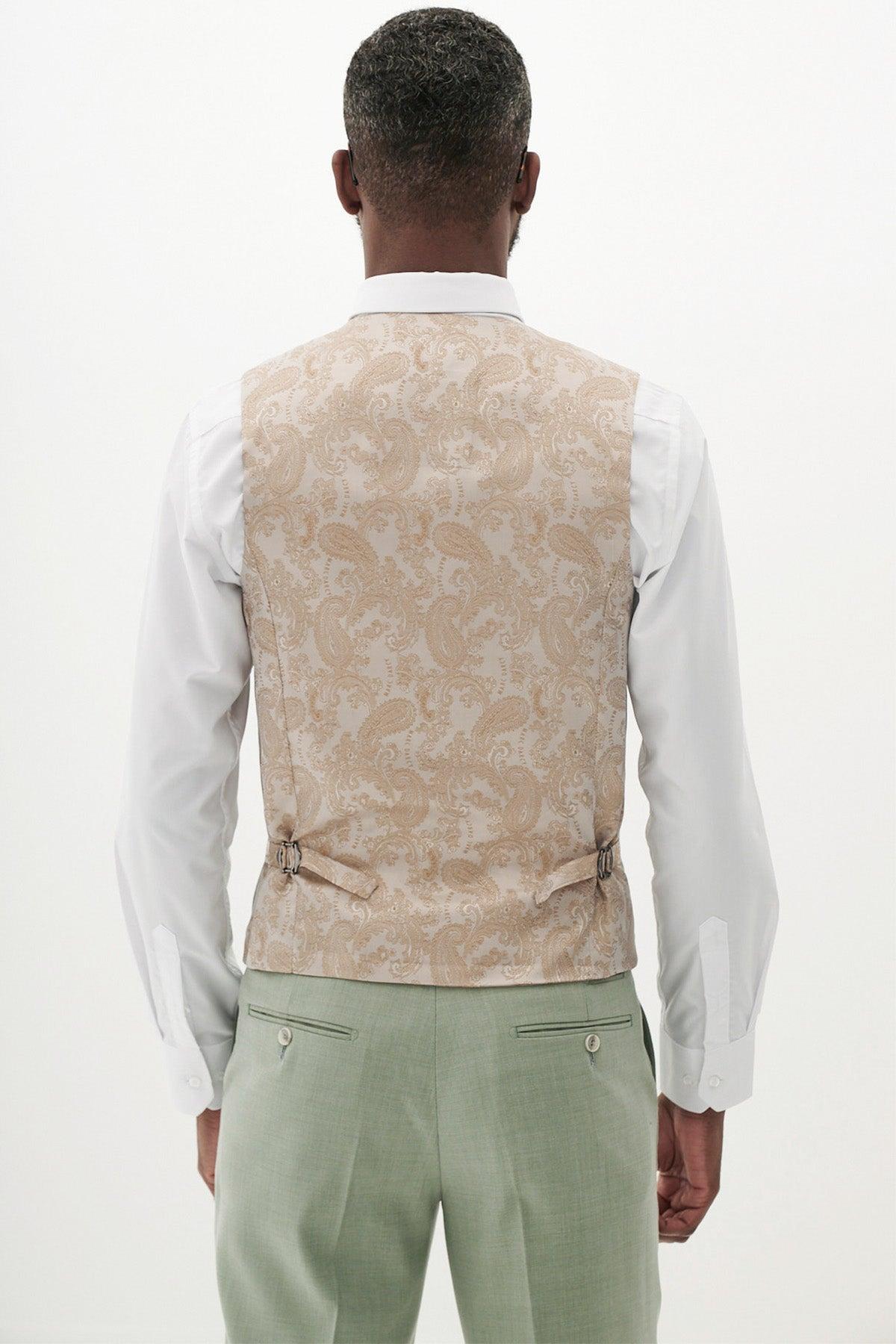 Man in a white shirt, Marc Darcy FINLEY moss green single breasted waistcoat with adjustable back straps, paired with light green pants—perfect for summer formalwear.