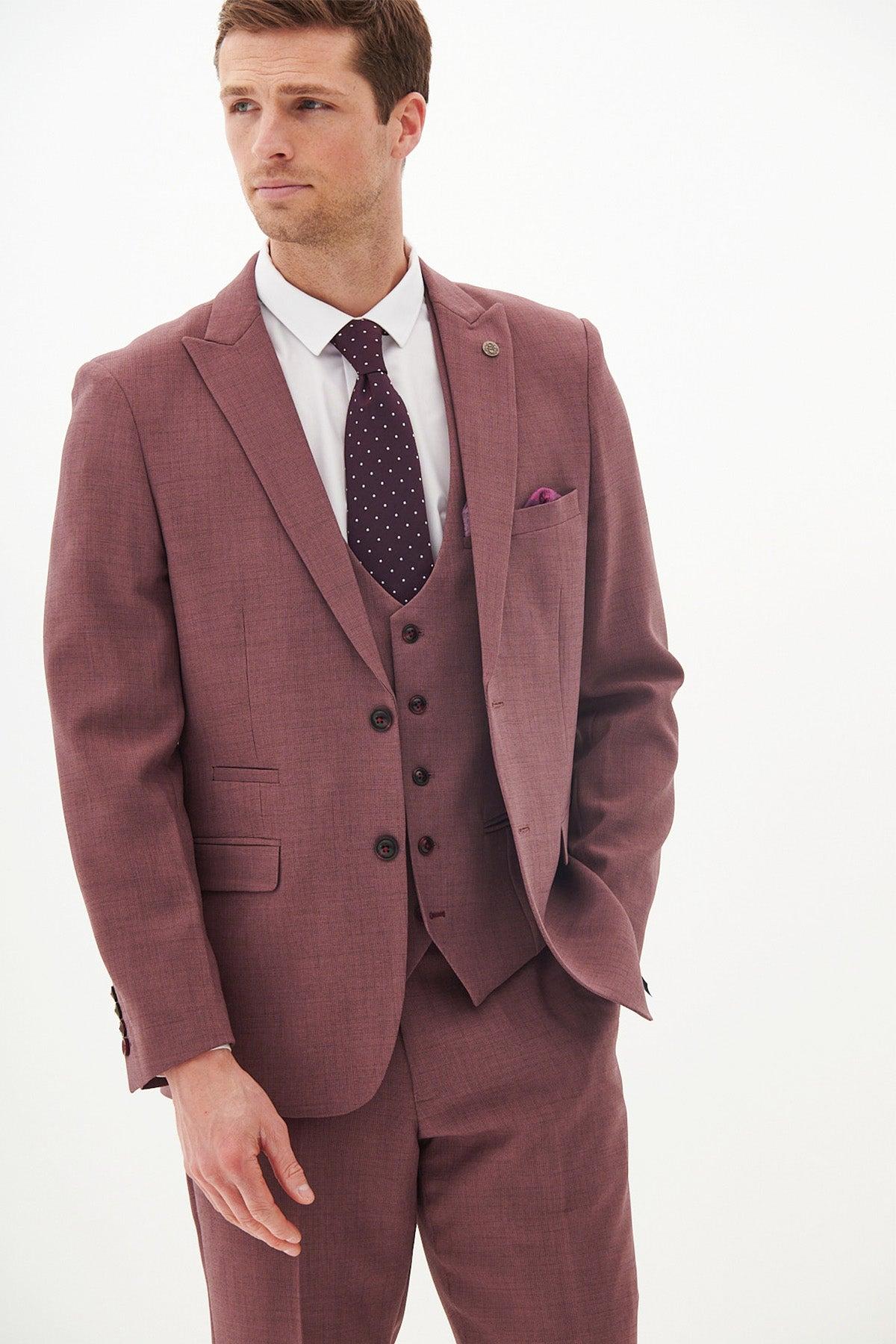 A man wears the Marc Darcy MONTY Mauve Three Piece Suit with a white shirt and a dark purple polka dot tie, complemented by a purple pocket square—an elegant summer wedding look.