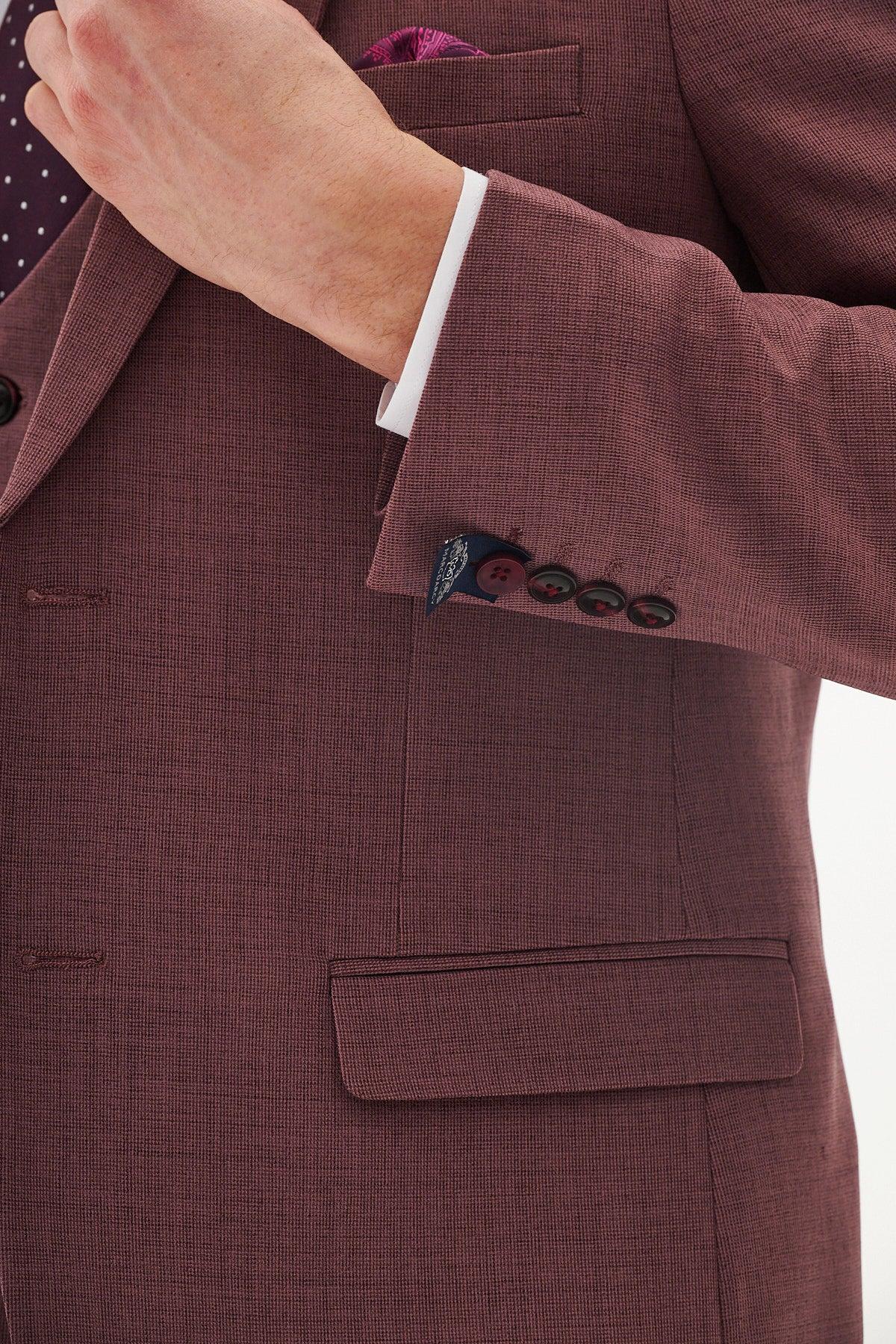 Close-up of a man wearing the Marc Darcy MONTY - Mauve Tailored Blazer with a white shirt, burgundy pocket square, and navy blue sleeve button detail—an ideal choice for formal occasions.