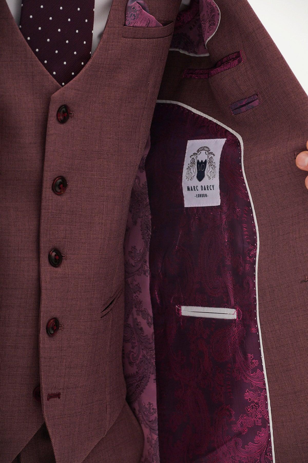 A person in a mauve tailored MONTY blazer by Marc Darcy holds open their suit, revealing a patterned purple lining and the Marc Darcy label—an effortless statement in modern formalwear.