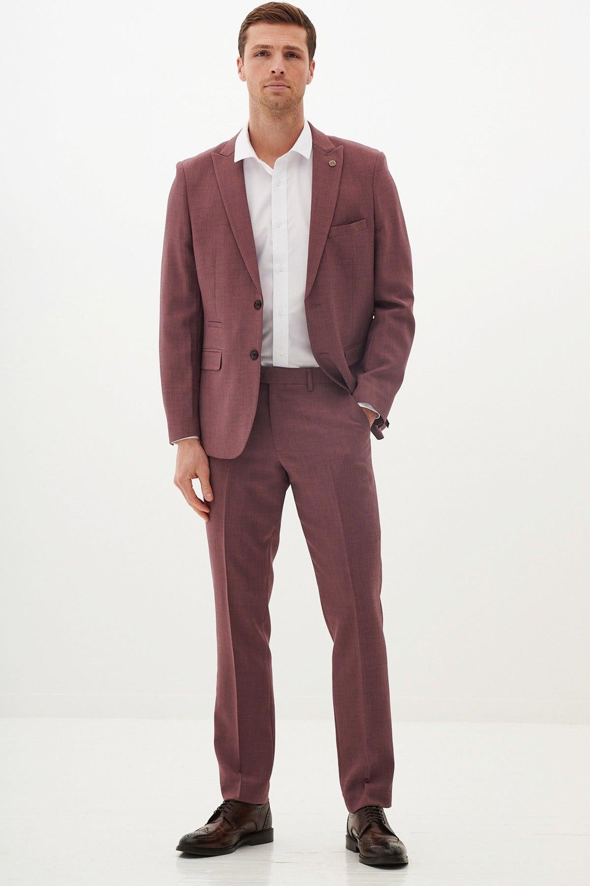 A man wears the Marc Darcy MONTY Mauve Two Piece Suit with a white dress shirt and brown dress shoes, standing against a white background.