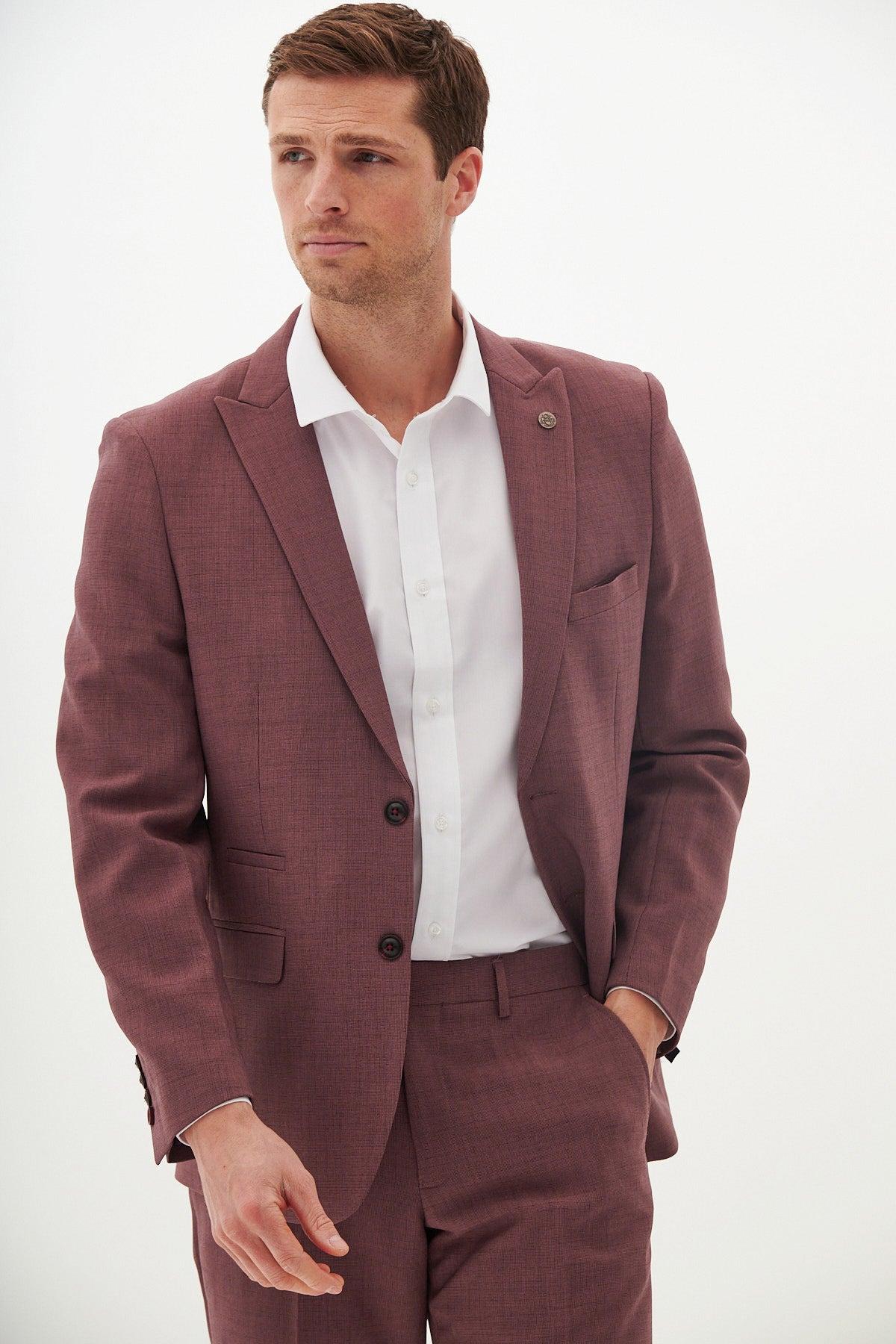 A man showcases modern formalwear in the Marc Darcy MONTY Mauve Tailored Blazer with a white shirt, his left hand casually placed in his pocket.