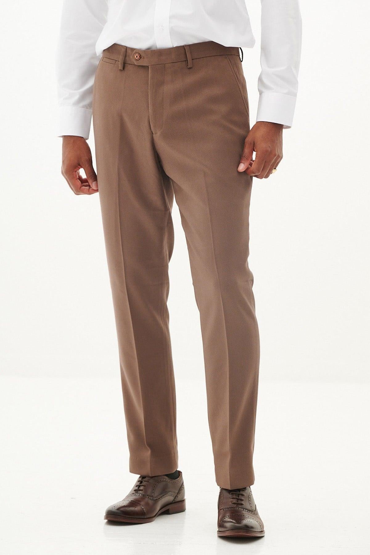 A person models the HM5 Tan Tailored Suit from The West Bromwich Albion F.C. Collection by Marc Darcy, as seen on Michael Johnston, styled with a white shirt and brown oxford shoes against a white background.