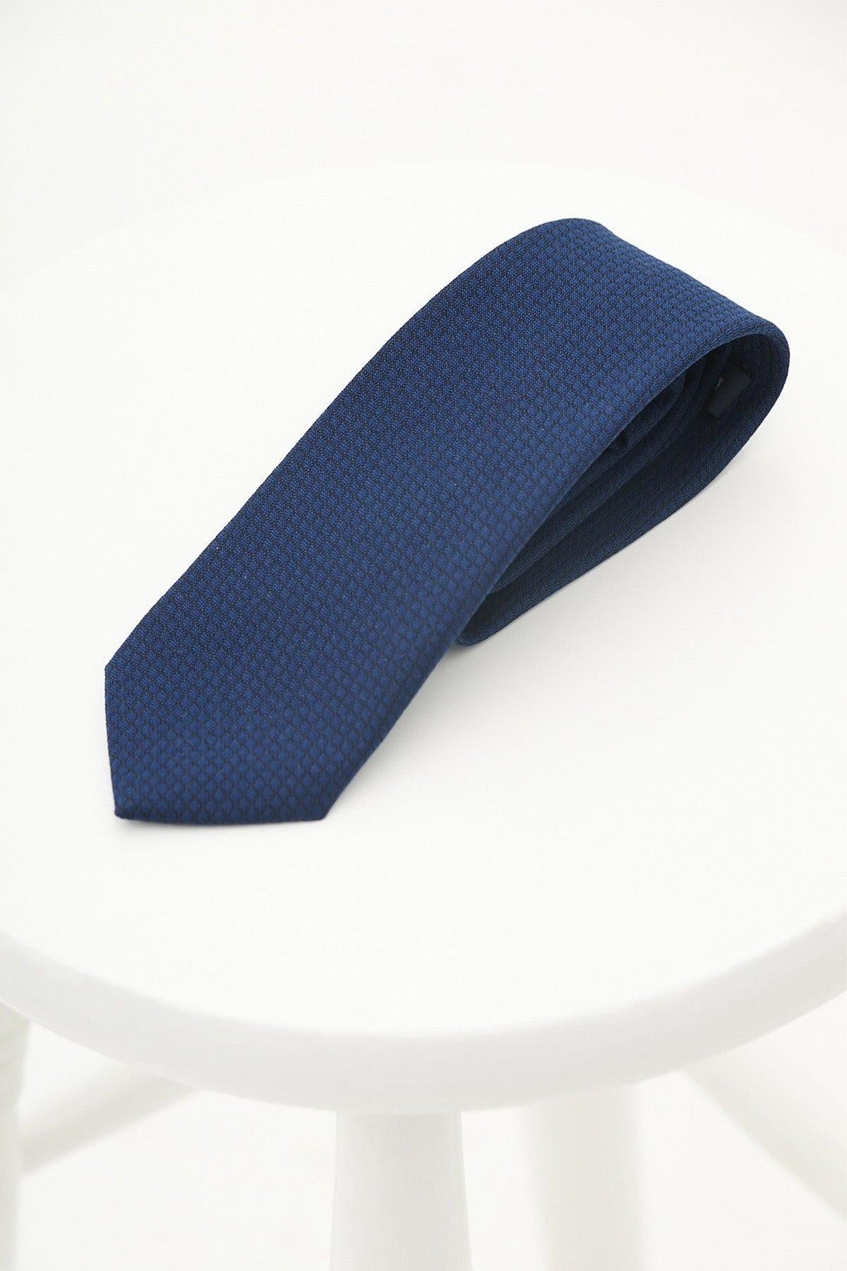 The MAX - Royal Diamond Print Tie by Accessory is neatly folded on a round white surface, ideal for formalwear or weddings, and showcased against a clean, bright background.