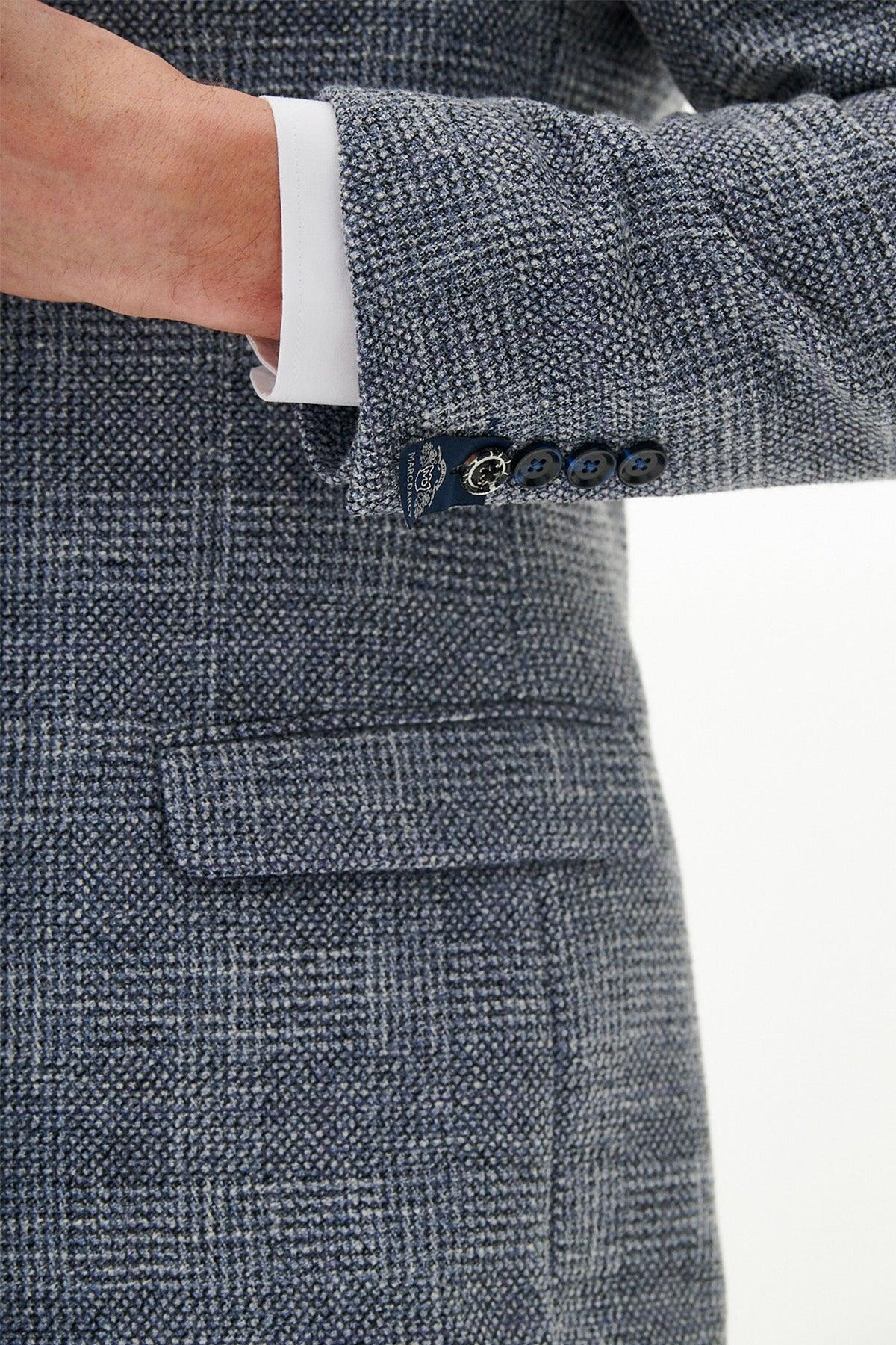 Close-up of the marcdarcy Official West Bromwich Albion F.C. Club Suit | KRIS Sky Blue Tweed Suit sleeve, showing a white shirt cuff, four dark buttons, and a navy crest label—refined details for this classic slim fit look.