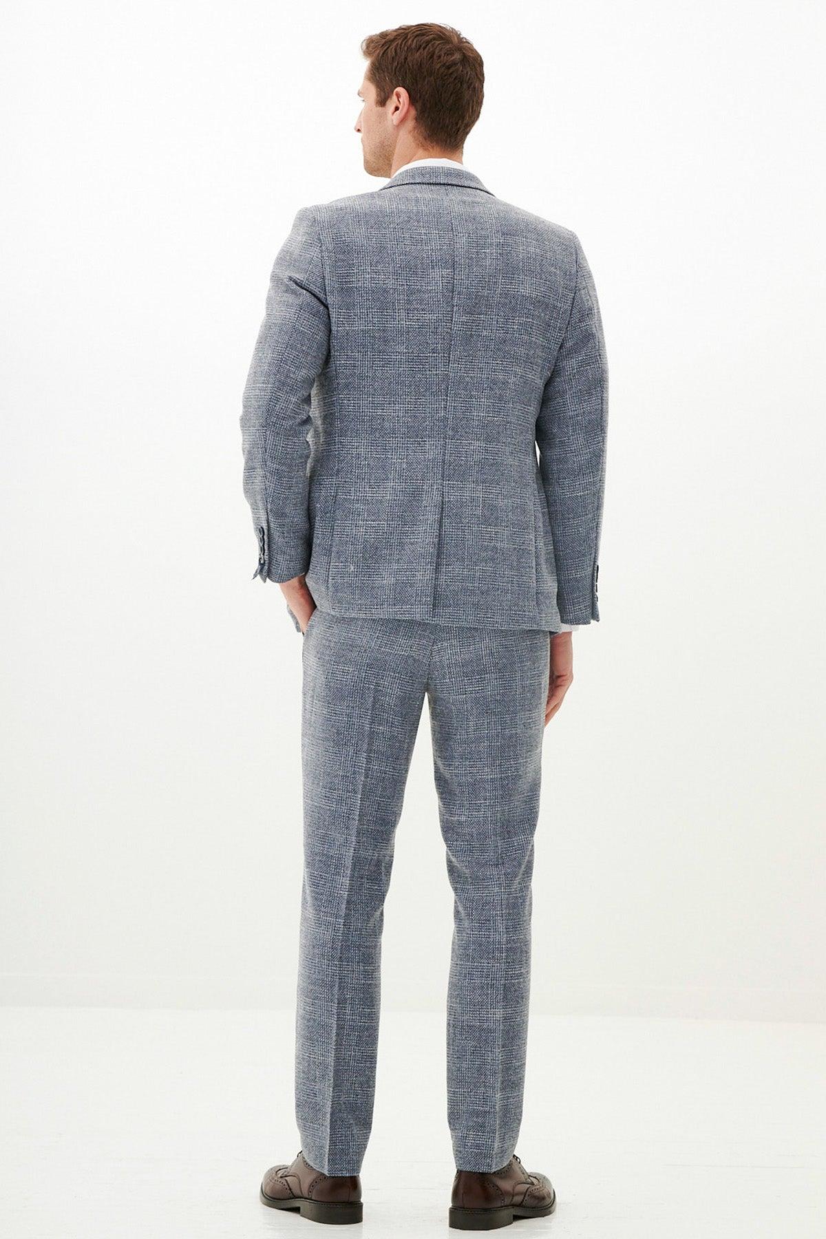 Back view of a man in a marcdarcy KRIS Sky Blue Tweed Suit with Kelvin Navy Waistcoat, styled slim fit and paired with brown dress shoes.
