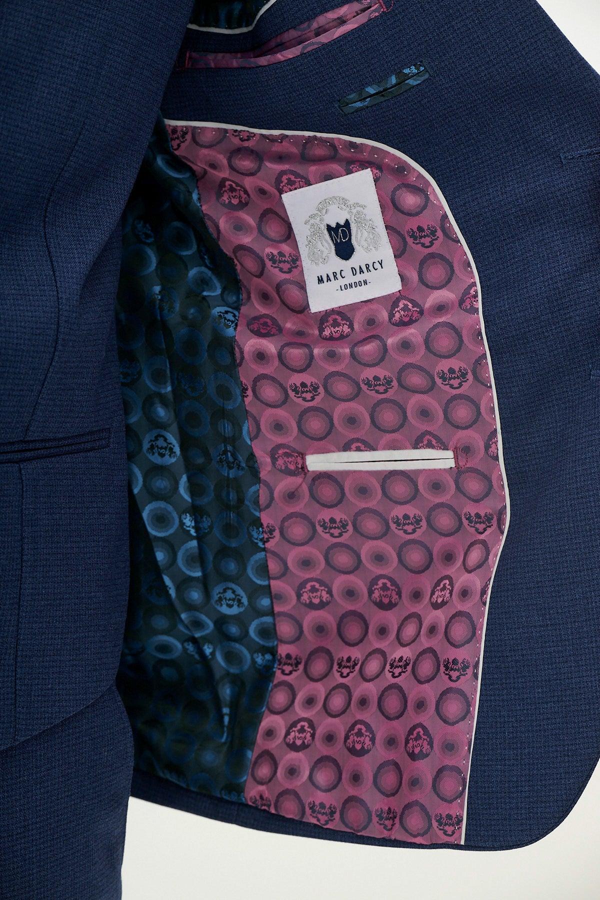 Close-up of the Official Cardiff City F.C. Club Suit by Marc Darcy shows the ASHLEY navy blue jacket interior, featuring pink and blue circular patterned linings, with a visible Marc Darcy label.