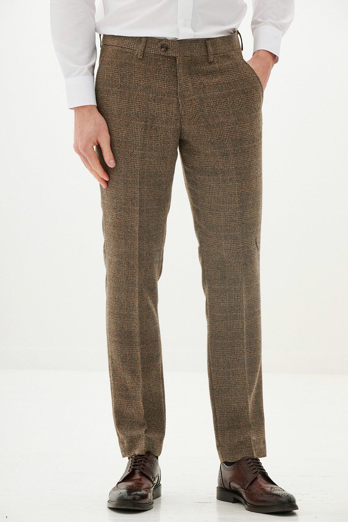 A man models the marcdarcy KRIS Tan Tweed Three Piece Suit with a white dress shirt and brown brogue shoes.