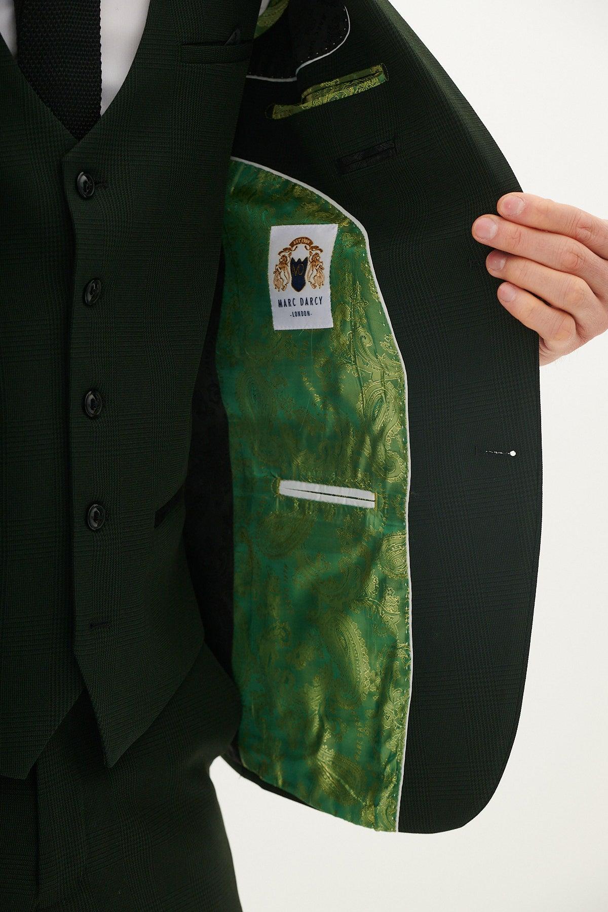 A person opens the BROMLEY Olive Green Check Blazer from The Cardiff City F.C. Collection by Marc Darcy, revealing a green paisley satin lining and a white label with a lion logo and Marc Darcy London text.