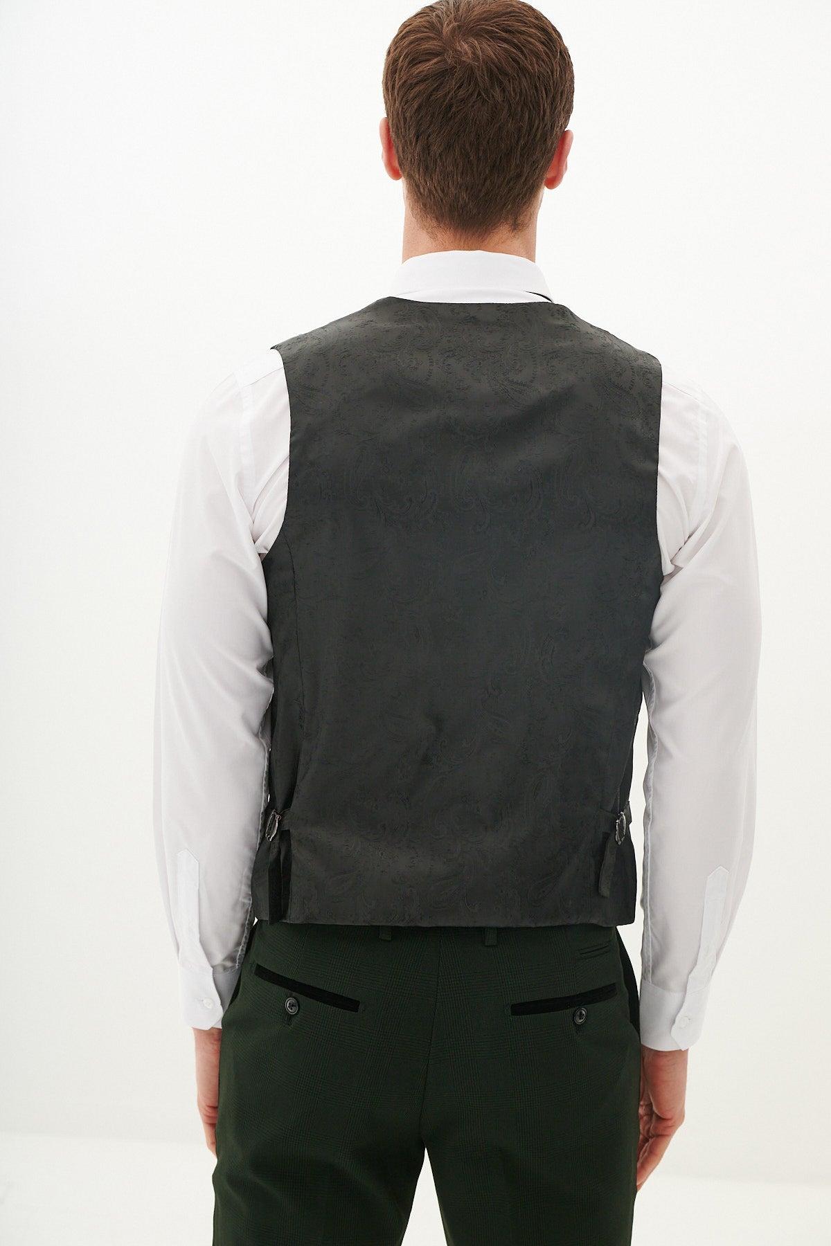 A man is seen from behind wearing a white dress shirt, dark green trousers, and the Marc Darcy BROMLEY Olive Green Single Breasted Check Waistcoat against a plain light background.
