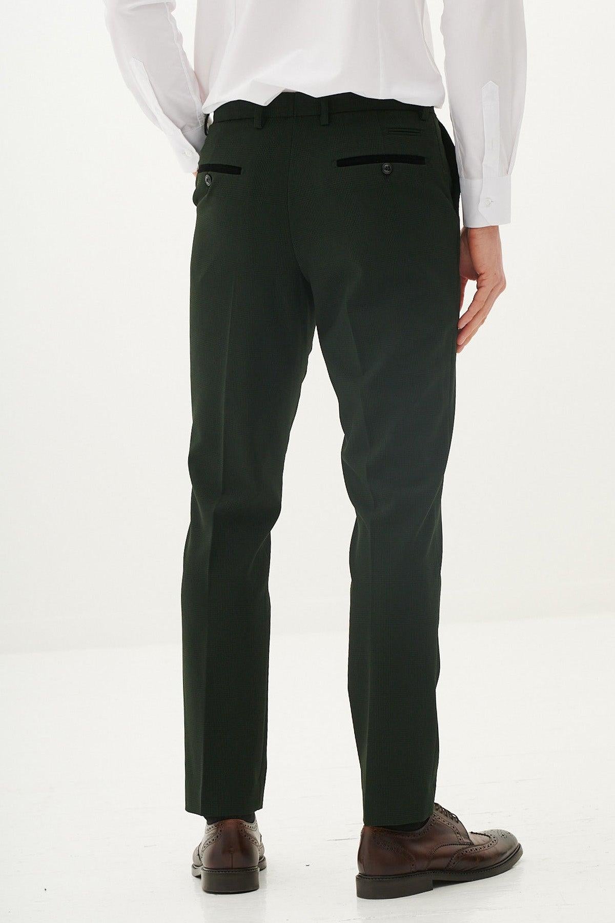 Back view of a man in the Marc Darcy BROMLEY Olive Green Check Suit with Kris Tan Tweed Waistcoat, styled with a white shirt and brown brogue shoes for a look of classic sophistication.