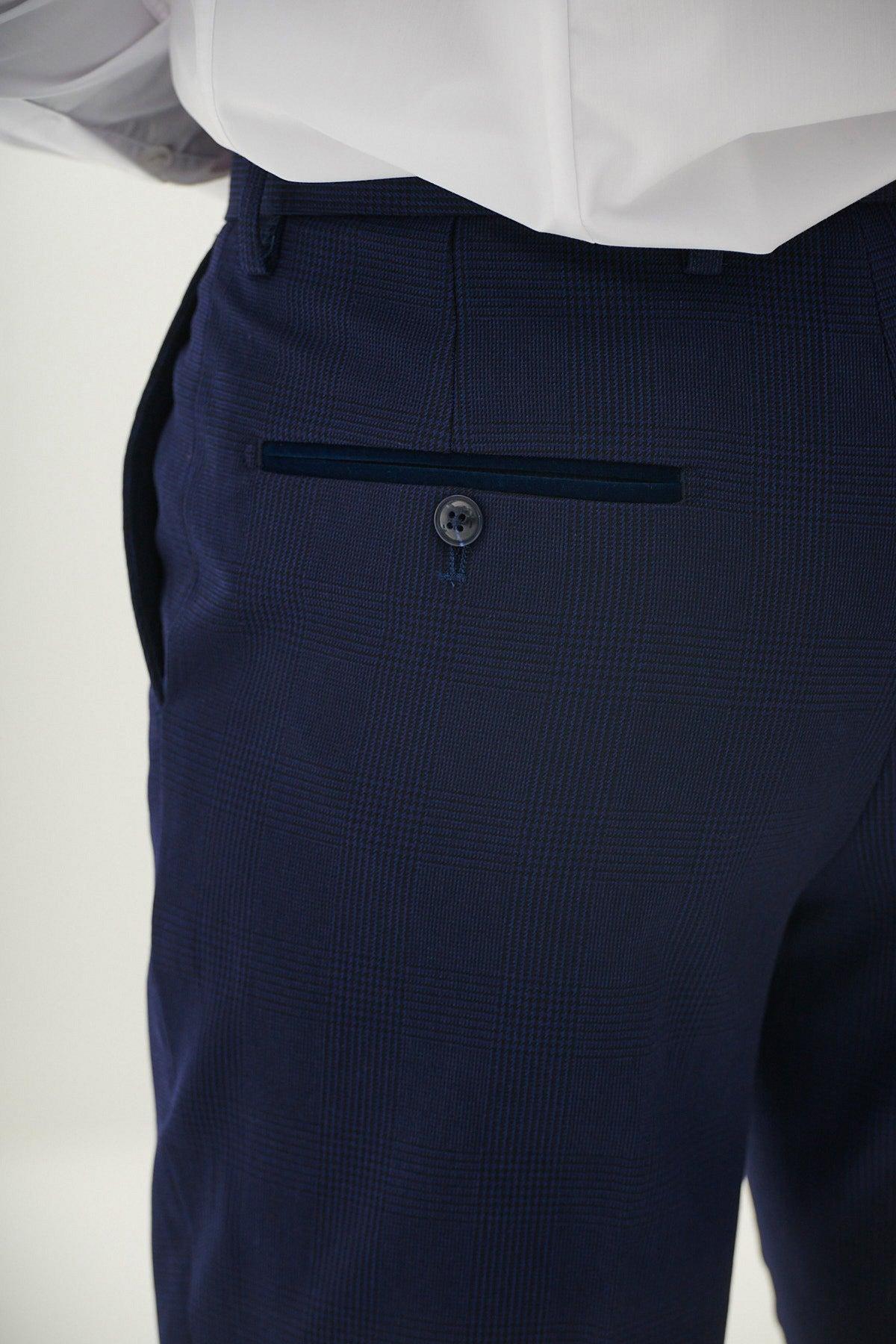 Close-up of the back pocket on Marc Darcy’s BROMLEY Navy Check Three Piece Suit, showcasing a Prince of Wales check, velvet trim, and button closure.
