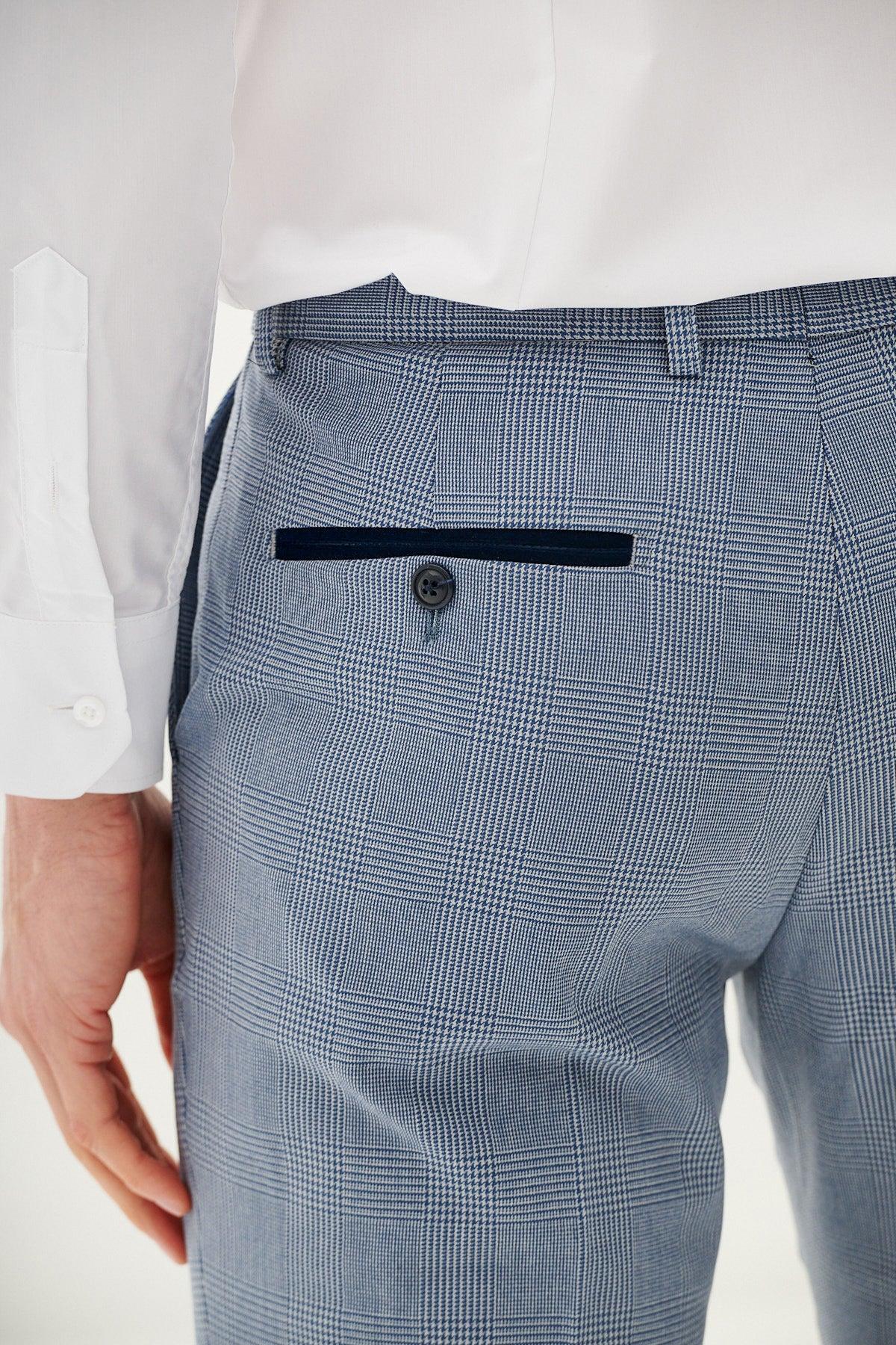 Close up of a man wearing a white dress shirt and the BROMLEY - Sky Blue Check Three Piece Suit by Marc Darcy. The suit pants feature a black velvet trim pocket with a black button.