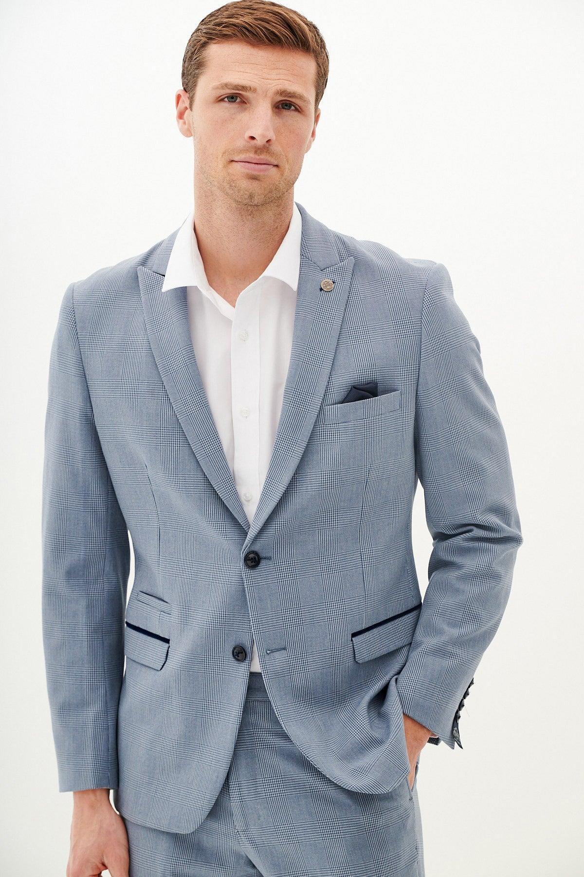 A man wears the Marc Darcy BROMLEY Sky Blue Check Blazer with a white shirt and a dark pocket square.