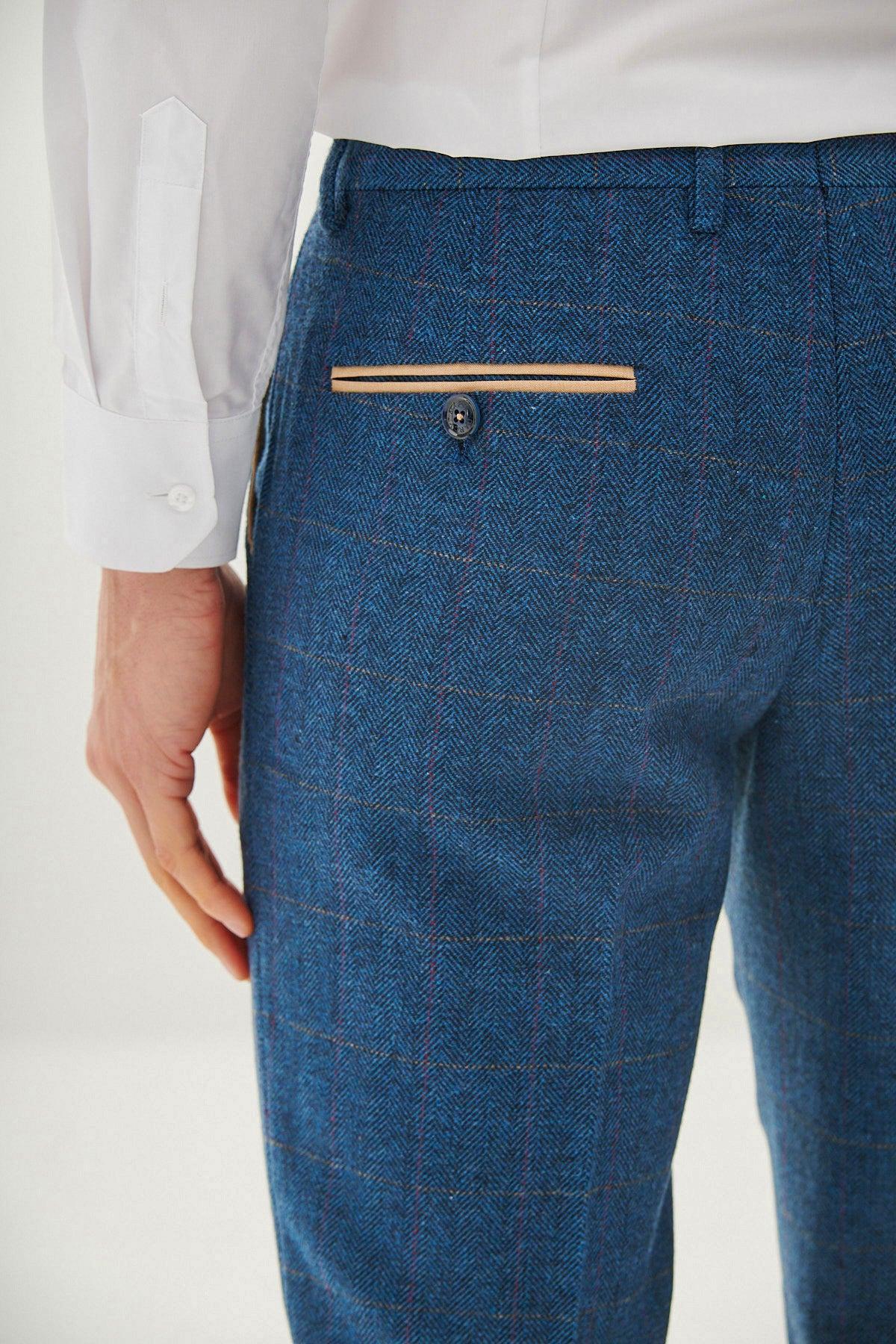 A person in a white dress shirt and marcdarcy DION Blue Tweed Check Trousers with a tan-trimmed back pocket and single button—only their back and arm visible. A stylish choice, ideal for a wedding outfit.