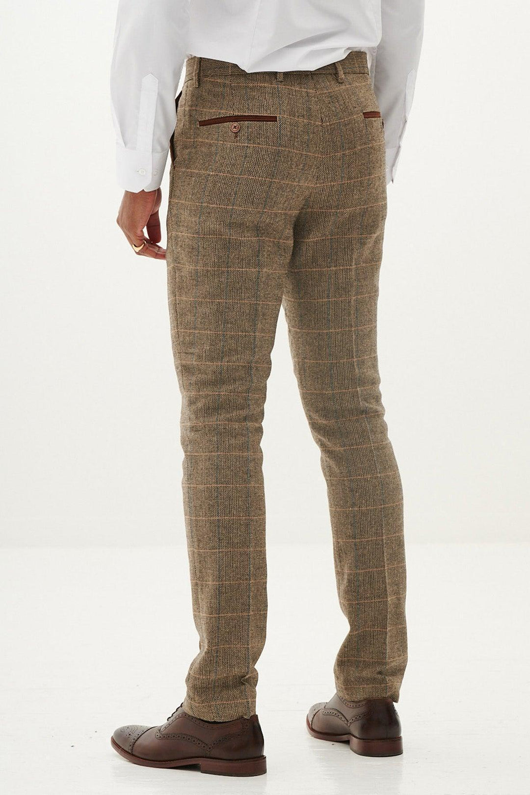 A person wearing marcdarcy's TED - Tan Tweed Check Trousers, a white dress shirt, and brown dress shoes stands on a white background, viewed from the back.