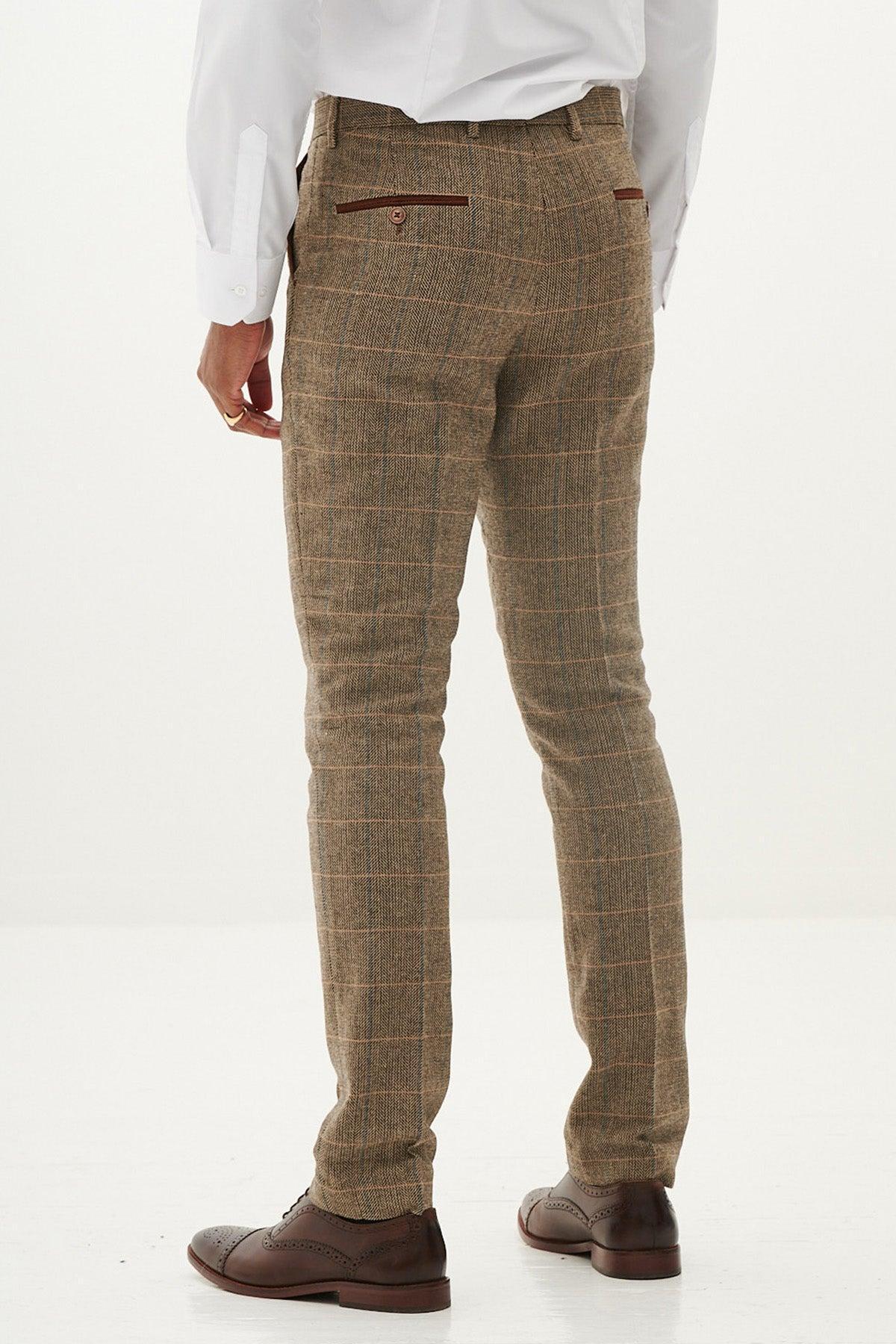 A person wearing marcdarcy's tan tweed check TED trousers with a white dress shirt and brown shoes is shown from the back on a white background—ideal for country barn weddings and crafted from luxe herringbone wool-mix.