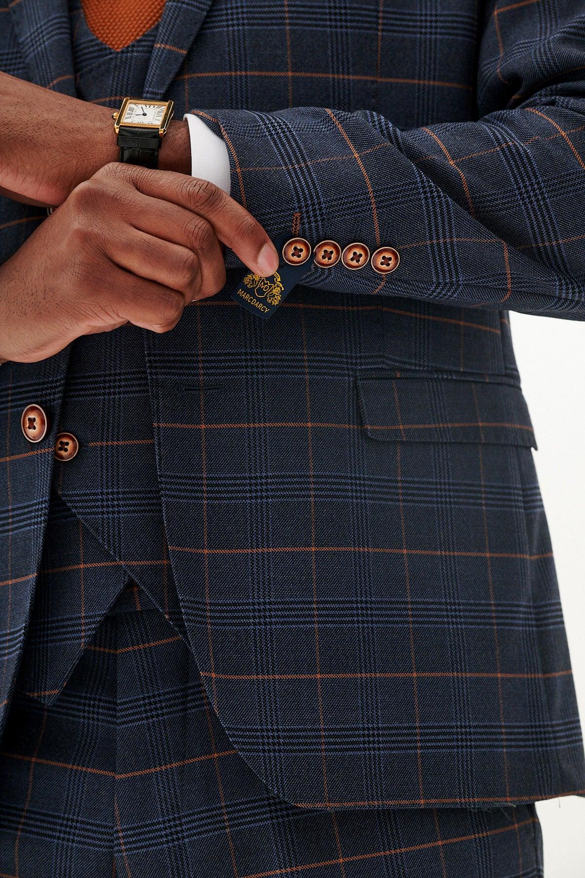 Close-up of a man's hands adjusting the sleeve of the marcdarcy JENSON - Marine Navy Check Blazer. A gold-faced watch peeks from his wrist, adding a refined touch—ideal for elevating your wedding suit style.